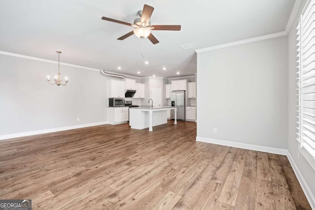 unfurnished living room featuring sink, ceiling fan with notable chandelier, ornamental molding, and light hardwood / wood-style floors