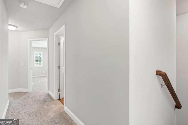 hallway featuring light colored carpet