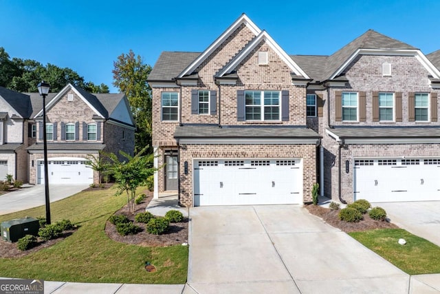 view of front of property with a garage and a front lawn