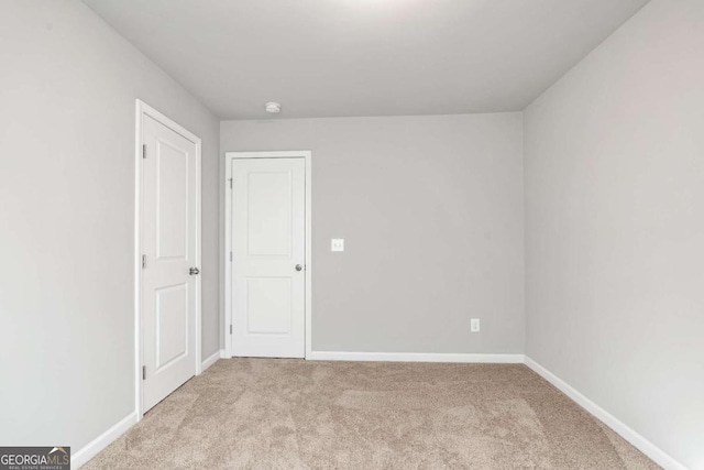 spare room with light colored carpet