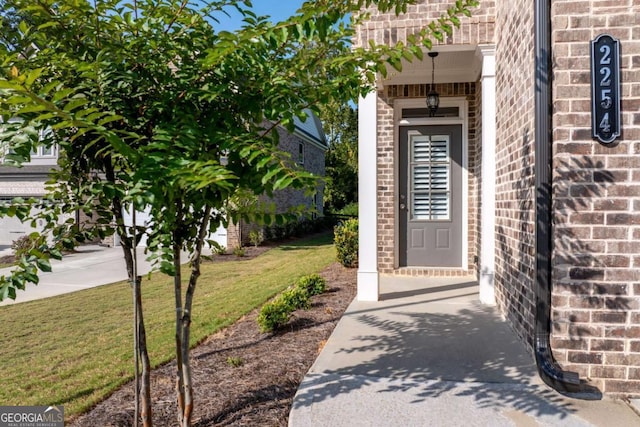 doorway to property with a yard