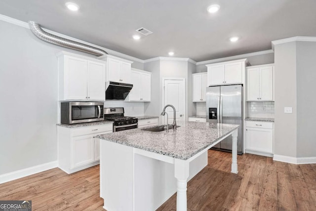 kitchen with extractor fan, appliances with stainless steel finishes, sink, and white cabinets