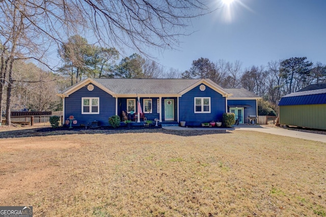 single story home featuring a porch and a front yard