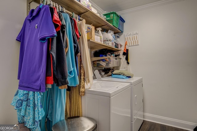 washroom featuring laundry area, wood finished floors, baseboards, washing machine and clothes dryer, and crown molding