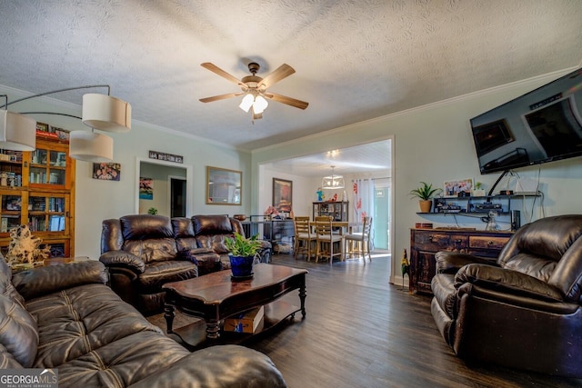 living room with dark wood-type flooring, ceiling fan, ornamental molding, and a textured ceiling