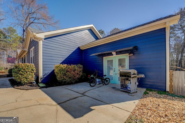 exterior space with french doors and fence