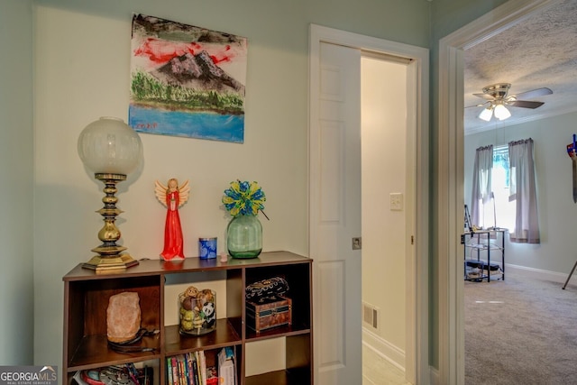 hallway featuring ornamental molding and carpet flooring