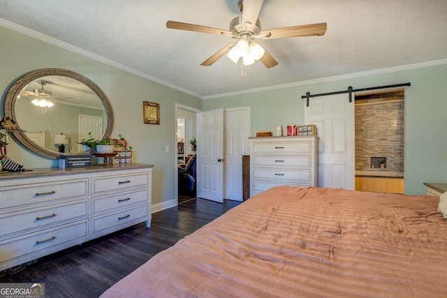 bedroom with crown molding, dark wood-type flooring, and a barn door