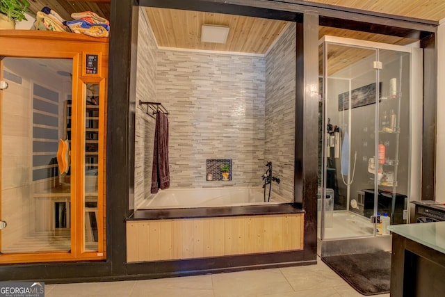 bathroom with separate shower and tub and tile patterned flooring