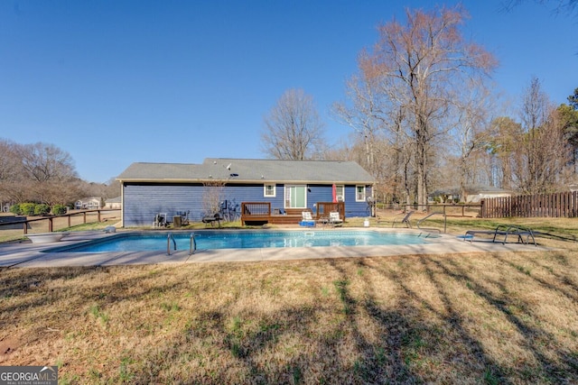 view of pool featuring a wooden deck and a yard