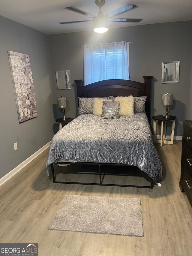 bedroom featuring light hardwood / wood-style flooring and ceiling fan