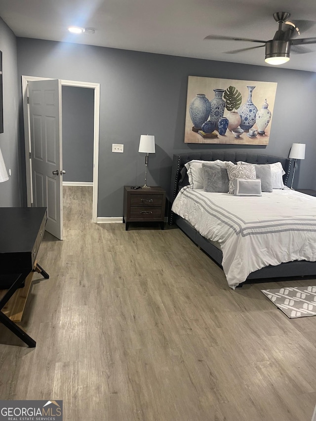 bedroom with hardwood / wood-style flooring and ceiling fan