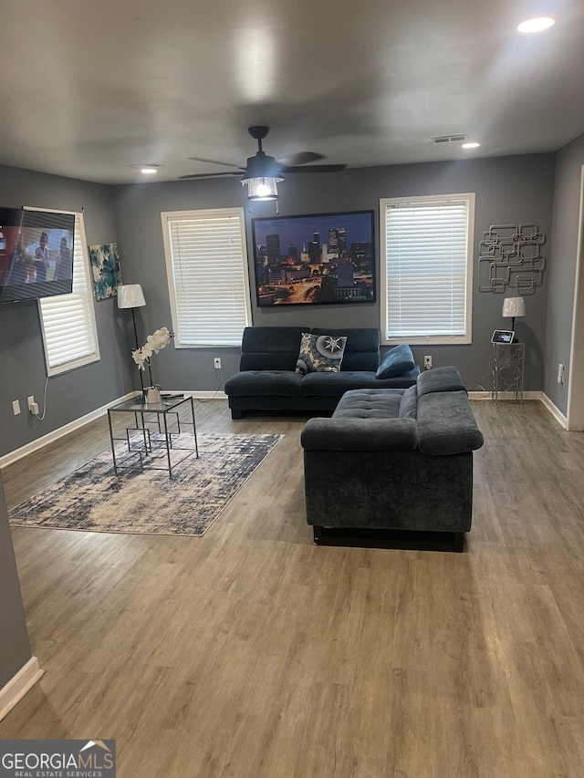 living room featuring hardwood / wood-style flooring and ceiling fan