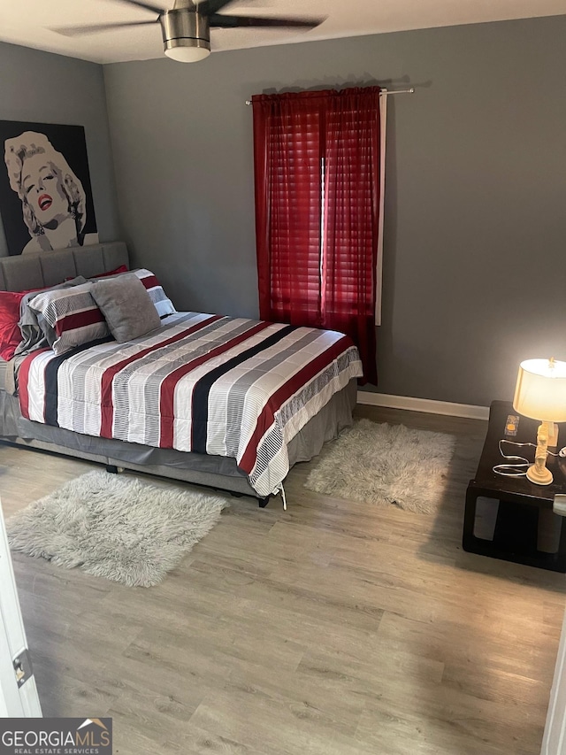 bedroom with hardwood / wood-style flooring and ceiling fan