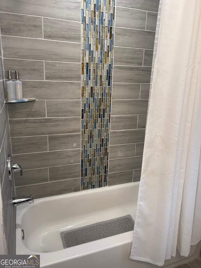 bathroom with shower / bathtub combination with curtain