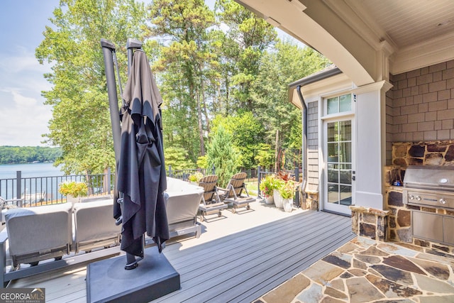 deck featuring grilling area and a water view