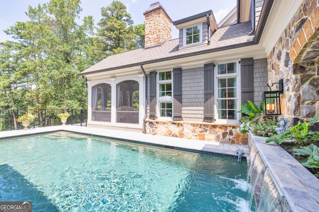 view of pool featuring a fenced in pool, a sunroom, and fence