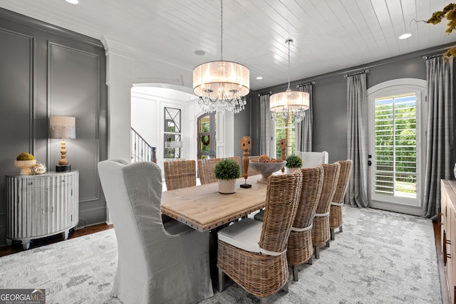 dining space with crown molding, a chandelier, and wood ceiling