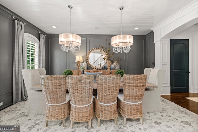 dining room with dark wood-type flooring and a notable chandelier