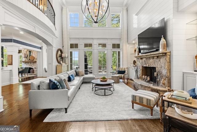 living room with a fireplace, wood finished floors, and a wealth of natural light