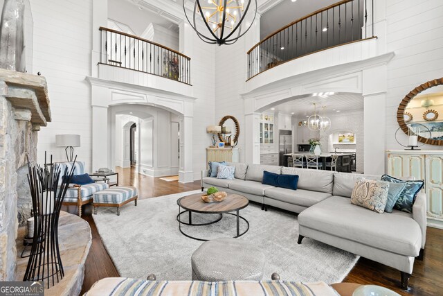 kitchen featuring built in appliances, wood ceiling, decorative light fixtures, and white cabinetry