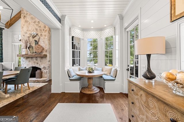 interior space with ornamental molding, dark wood-type flooring, wooden ceiling, and breakfast area