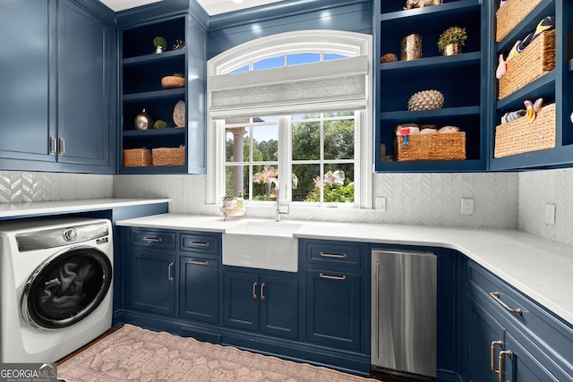 laundry room with cabinets, washer / dryer, and sink