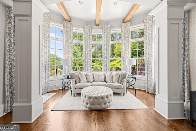 sunroom with beam ceiling and ornate columns