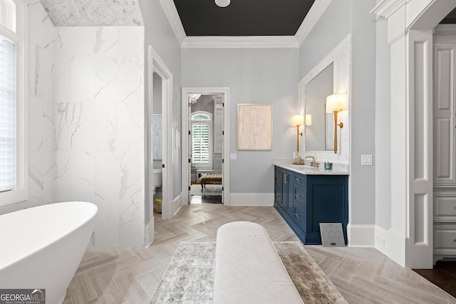 full bathroom with crown molding, a freestanding bath, connected bathroom, vanity, and baseboards