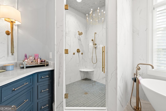 full bath with a freestanding tub, vanity, and a marble finish shower