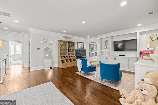 living room featuring dark wood-type flooring and crown molding