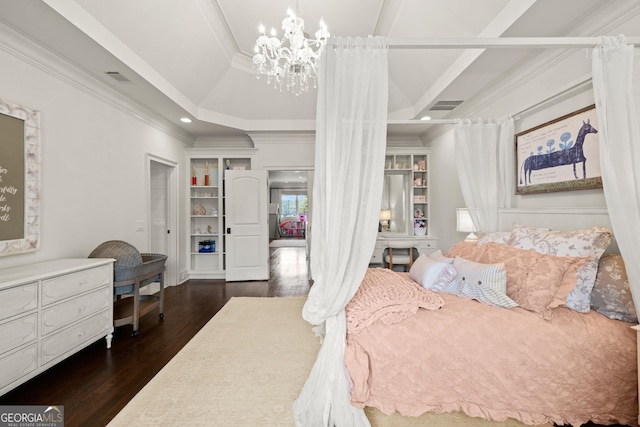 bedroom with a tray ceiling, dark wood-type flooring, ornamental molding, and a chandelier