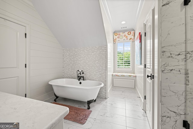 full bath with marble finish floor, recessed lighting, visible vents, a freestanding bath, and vaulted ceiling