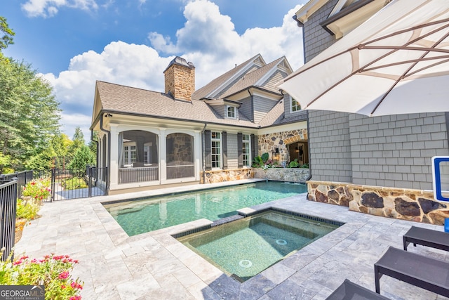 view of swimming pool featuring a patio, an in ground hot tub, fence, french doors, and a fenced in pool