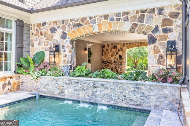 view of pool with pool water feature