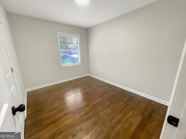 empty room with dark wood-type flooring