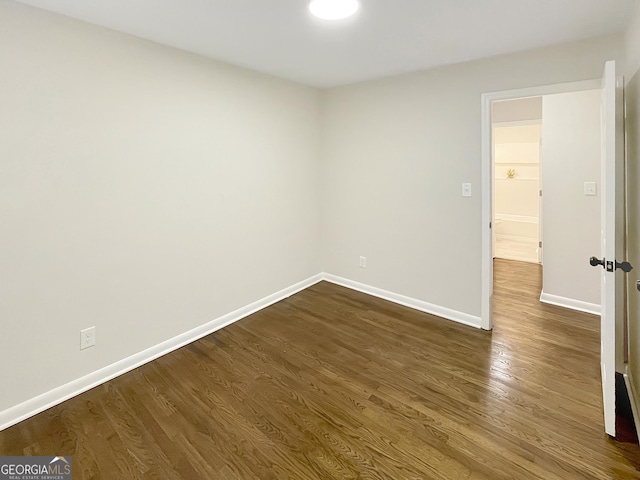 unfurnished room with dark hardwood / wood-style floors