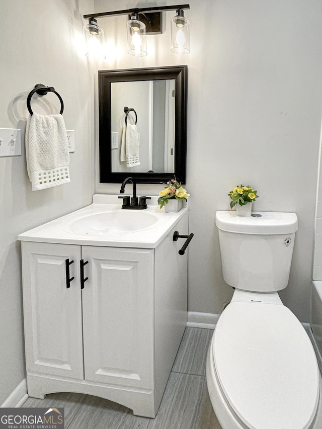 bathroom with vanity, toilet, and a bathing tub