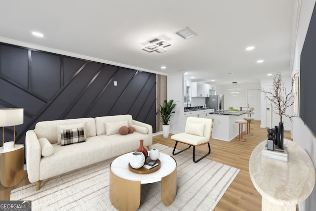 living area featuring light wood-style floors, visible vents, and recessed lighting