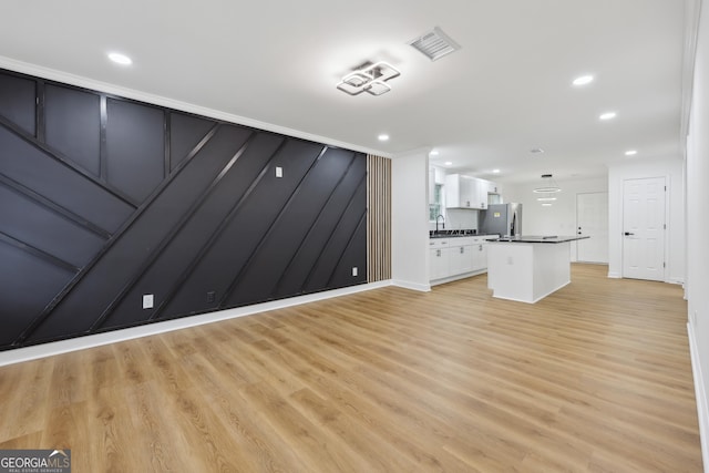 unfurnished living room featuring recessed lighting, visible vents, and light wood-style flooring