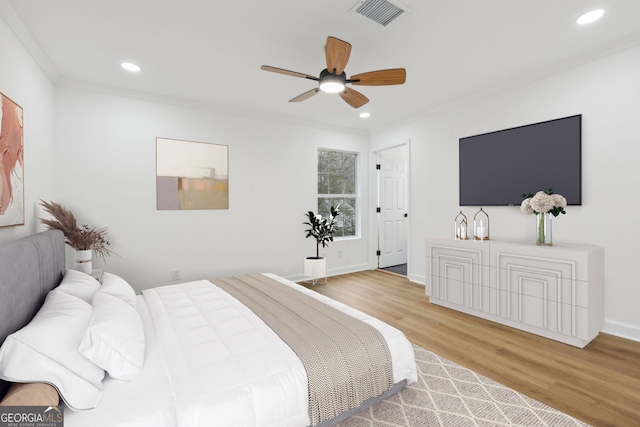 bedroom featuring recessed lighting, visible vents, crown molding, and wood finished floors