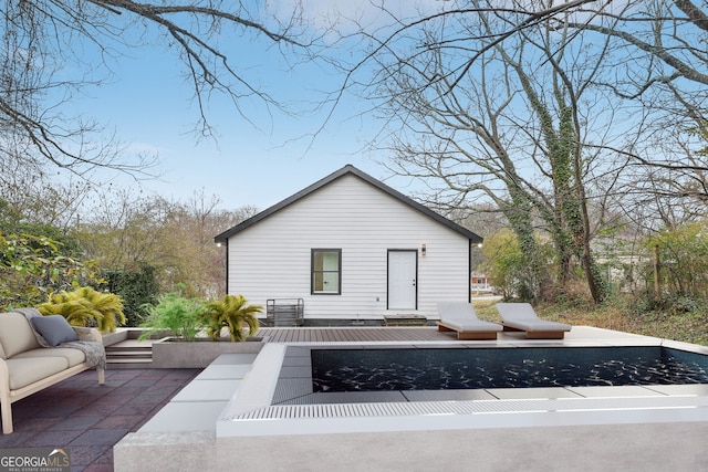 exterior space featuring a wooden deck and an outdoor hangout area