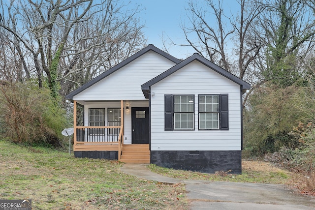 bungalow-style home featuring covered porch and crawl space