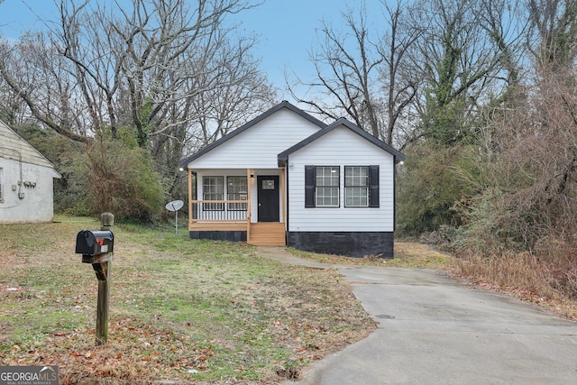 bungalow-style house featuring a front lawn and crawl space