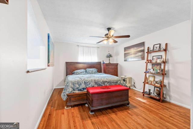 bedroom featuring ceiling fan and hardwood / wood-style floors