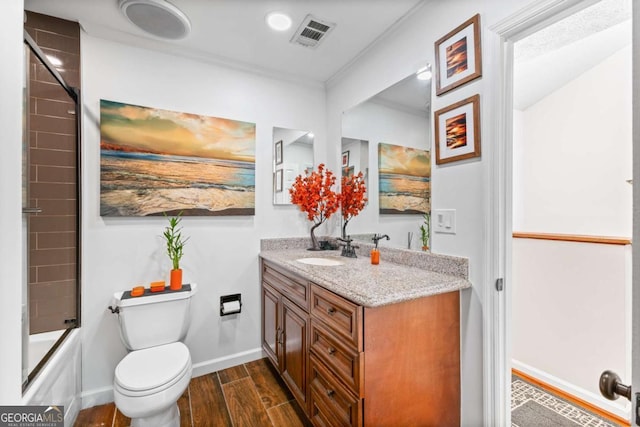 full bathroom with toilet, wood-type flooring, bath / shower combo with glass door, and vanity