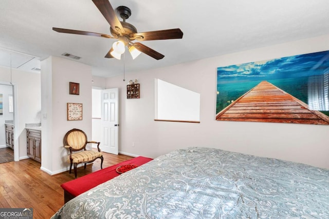 bedroom featuring hardwood / wood-style flooring, ceiling fan, and ensuite bath