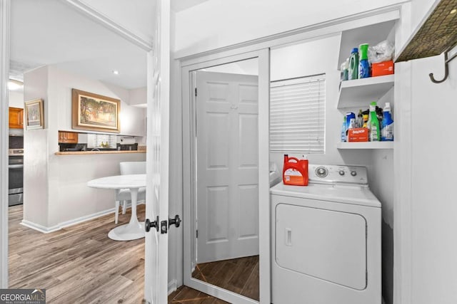 laundry room with hardwood / wood-style flooring and washer / dryer