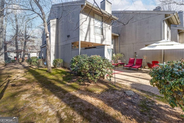 view of side of home with a patio