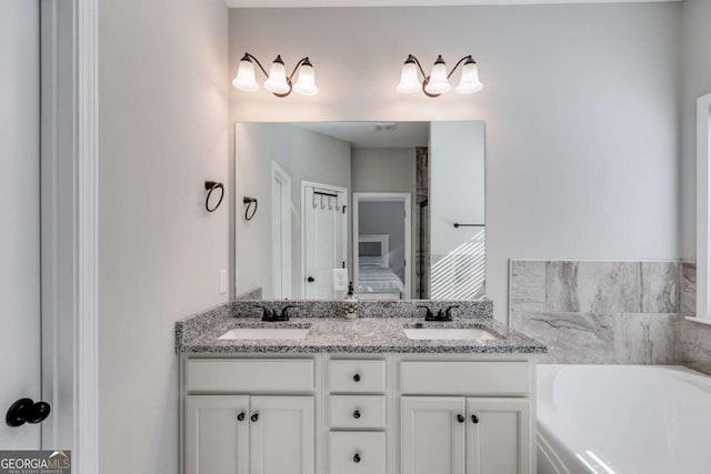 bathroom with vanity and a washtub